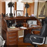 F108. Antique roll top desk and desk chair. 